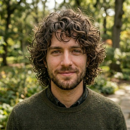 Curly shag medium hairstyle for men with layered curls and messy volume