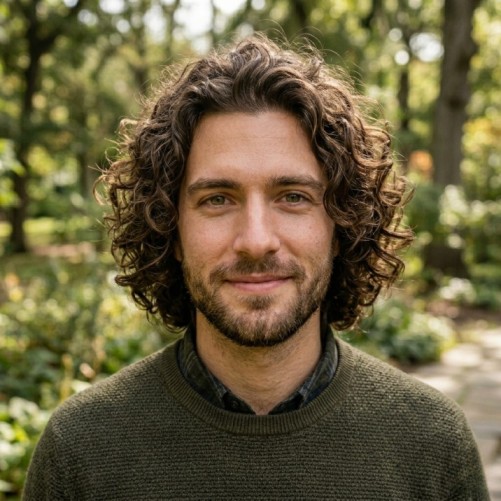 Loose curly medium hairstyle for men with soft volume and natural curl pattern