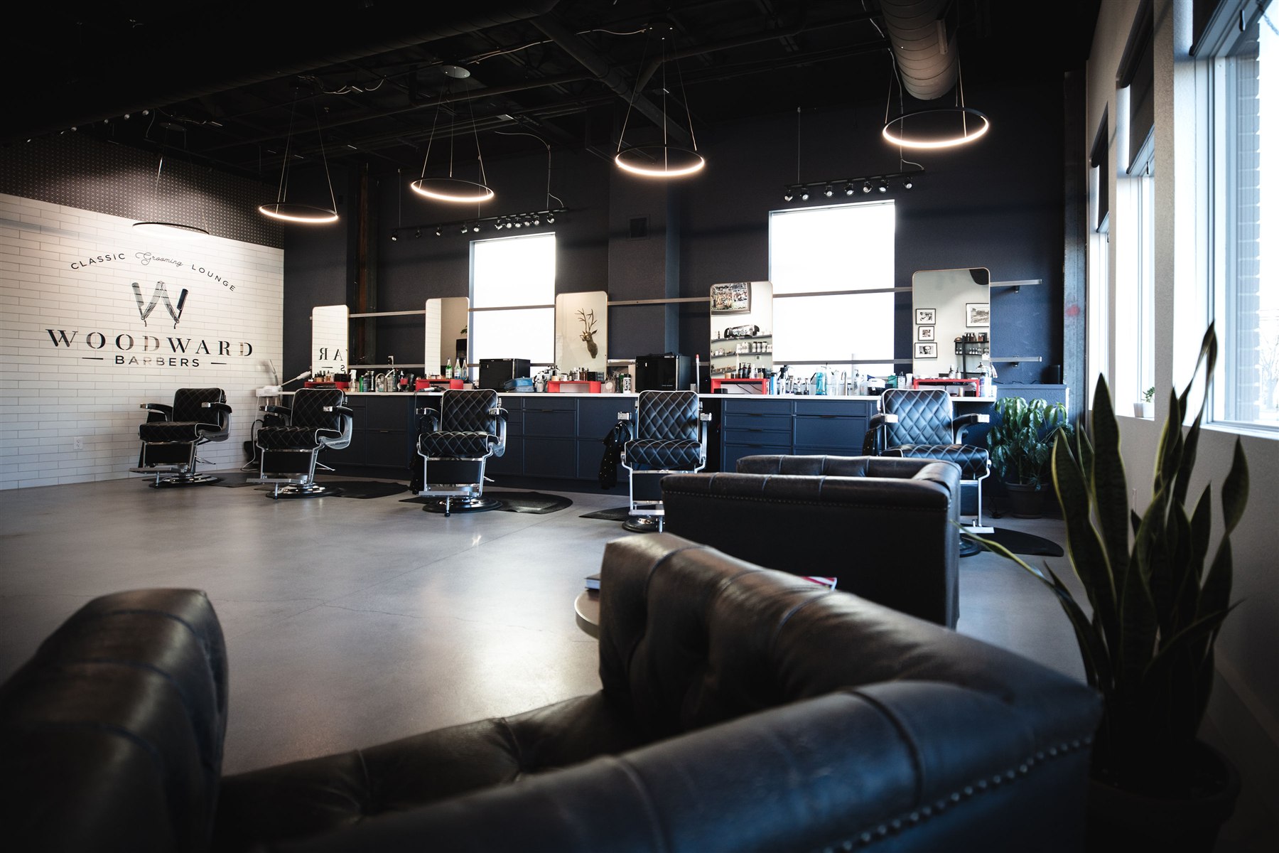 Classic Woodward barbershop interior with leather chairs and pendant lights